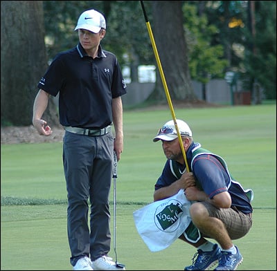 Joe Highsmith consults with his caddie during round 2 of the 2016 Washington State Men's Amateur, being held at Tacoma Country & Golf Club.