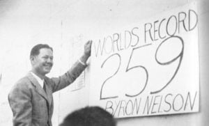 Byron Nelson stands next to sign that says 