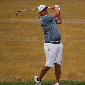 Hatley hits his tee shot on the 16th hole.