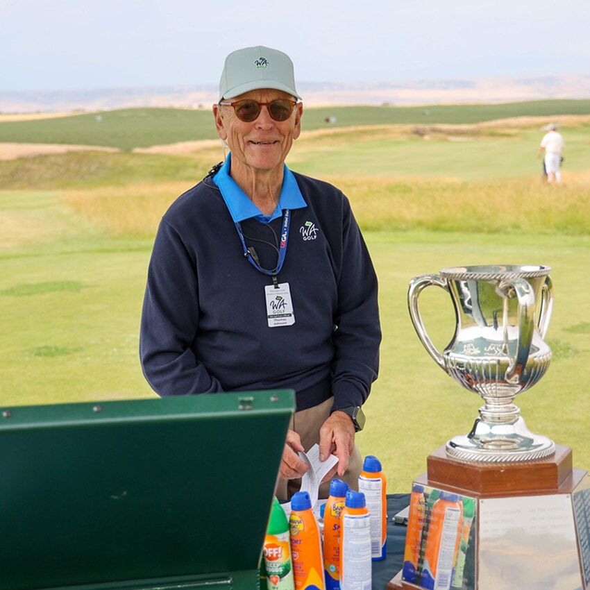 Volunteer at a WA Golf Championship starting tent.