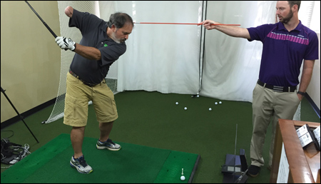 Mark gets a lesson from Jordan Cooper at the GolfTEC center in Tukwila, Wash.