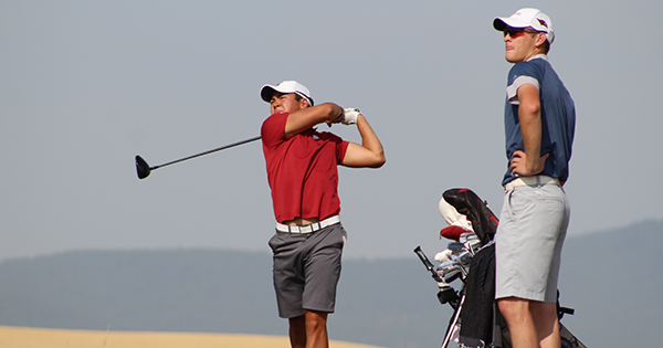 Daisuke Nakano (Pullman) hits a shot on the 12th hole as playing partner Nathan Cogswell (Kent) looks on.