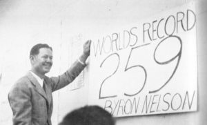 Byron Nelson stands next to sign that says "World's Record 259 Byron Nelson"